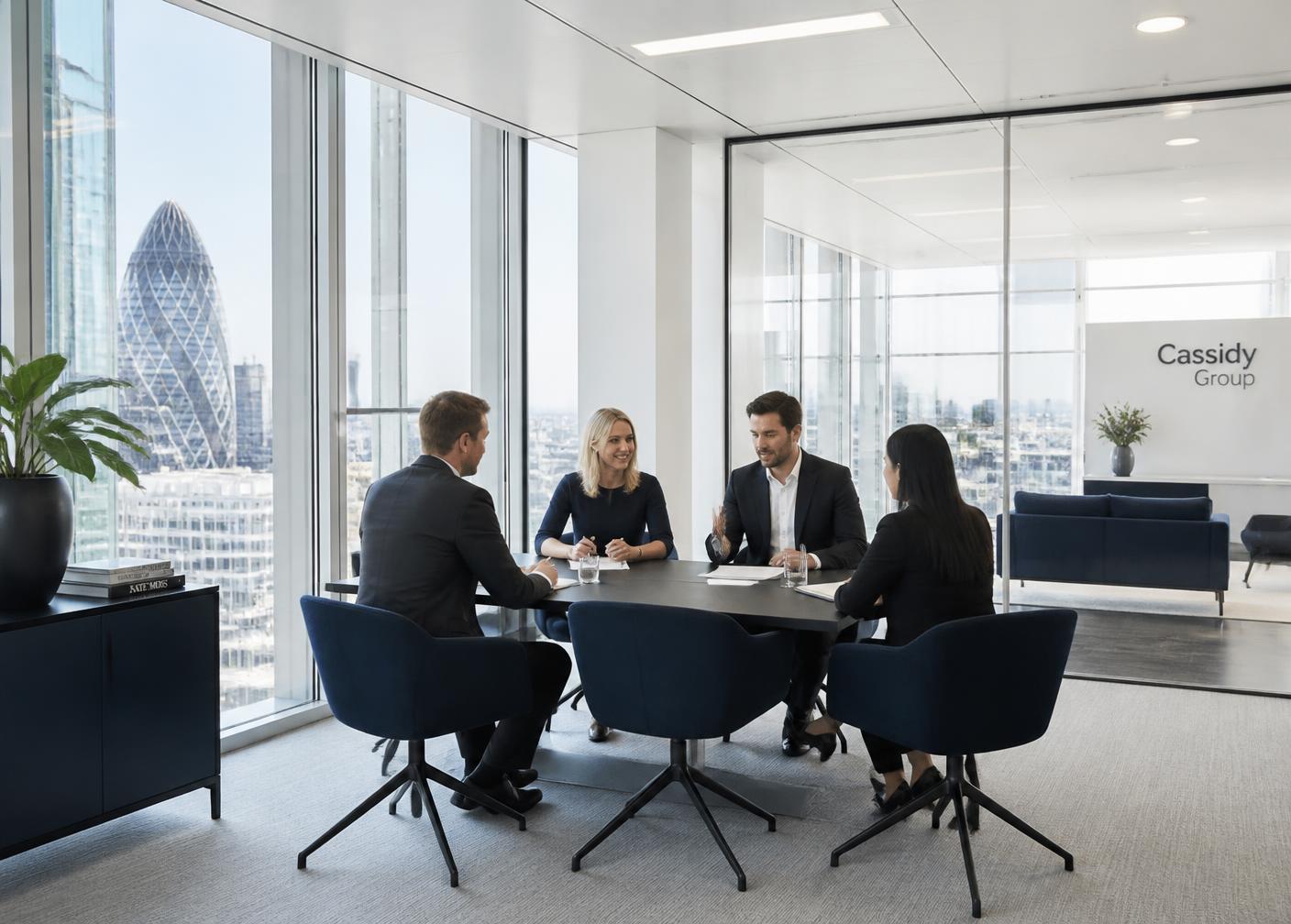 Business team meeting in a bright modern London office with a view of the City